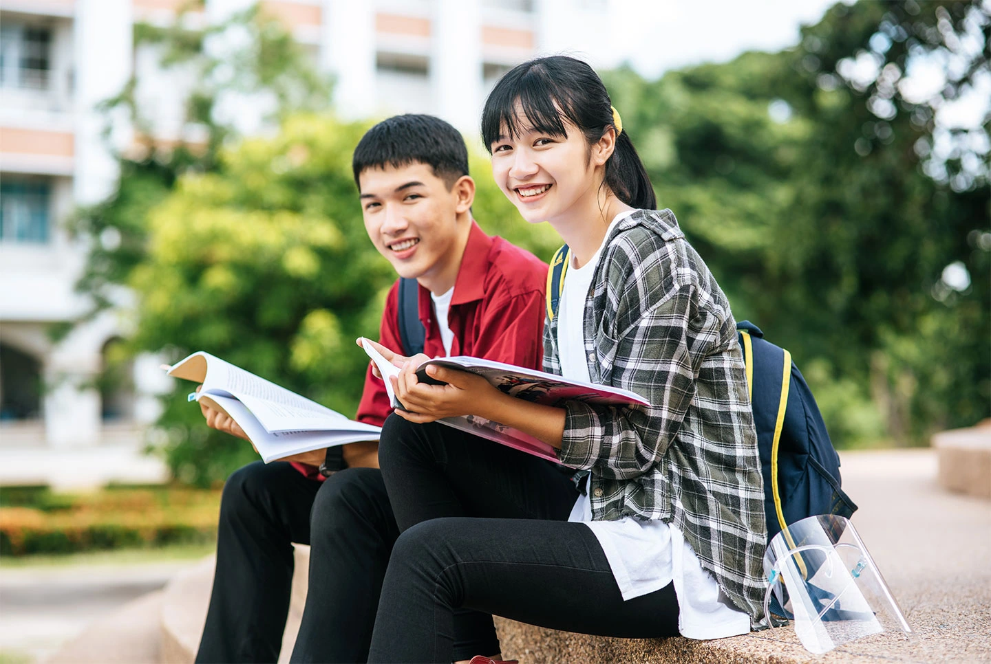 Two international students arriving in Singapore to begin their studies.
